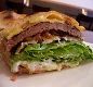 Beirutes Santos - Ingredientes: Hamburguer, queijo prato, presunto, bacon, ovo frito, alface, tomate e maionese.